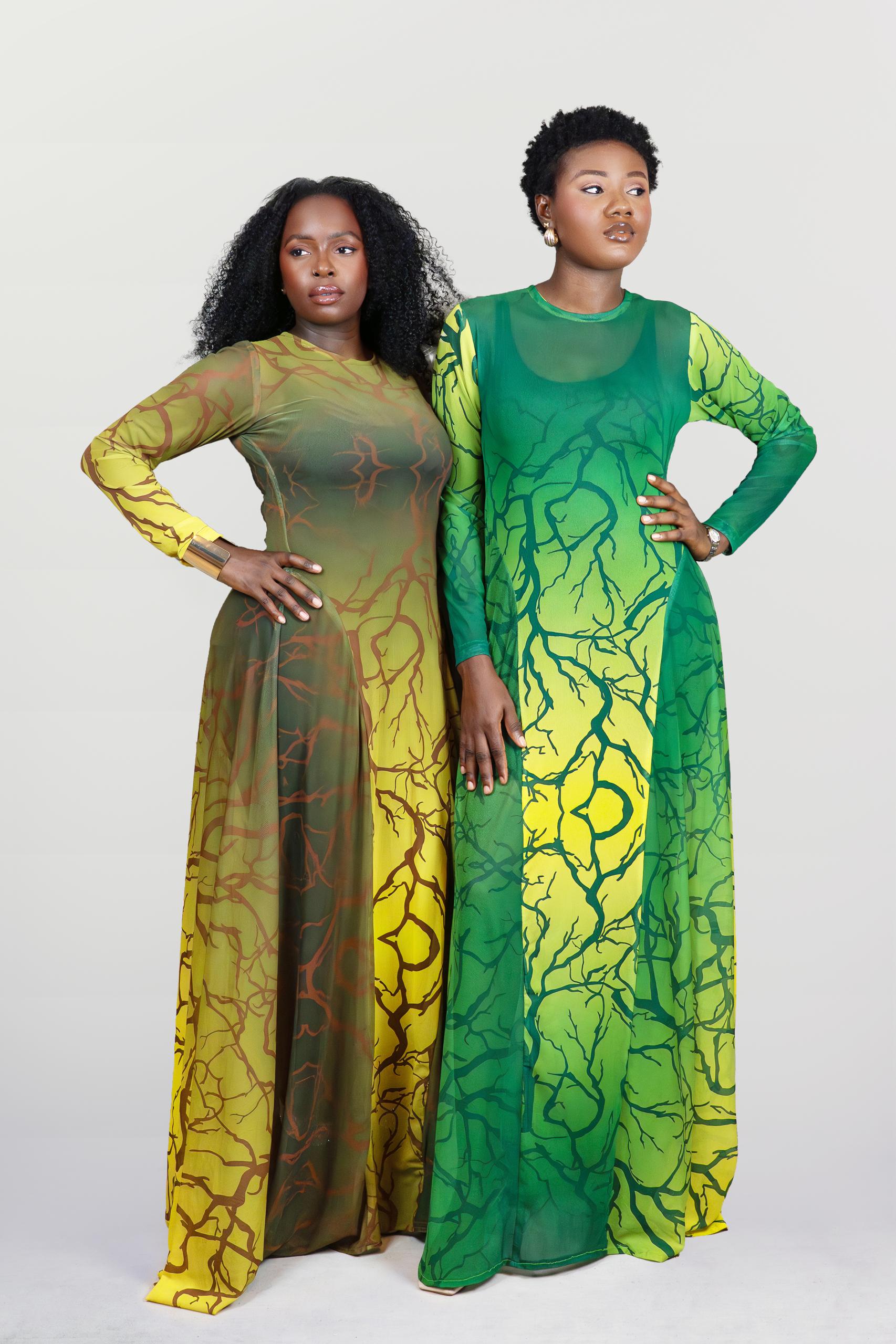 Two women wearing green and yellow patterned dresses on a white background